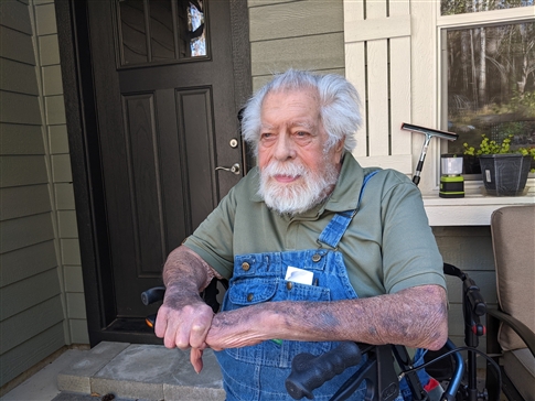 Jim Baker sits on his front porch in Vida